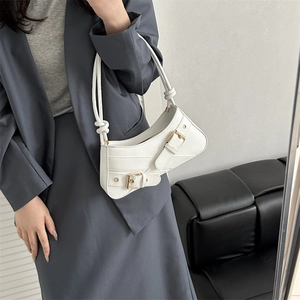 Chic white faux leather underarm bag with metal buckle straps and knotted shoulder strap