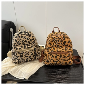 Close-up of leopard print corduroy mini backpacks with dual zippers and adjustable straps