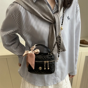 Black quilted bucket bag with gold chain strap and pink leopard print silk scarf handle