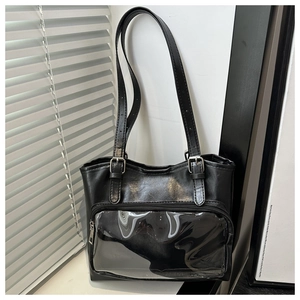 Detail of black ita bag showing transparent PVC window and silver metal buckles on straps