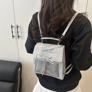 Silver metallic backpack with bow lace-up design and mesh panel for school and commute