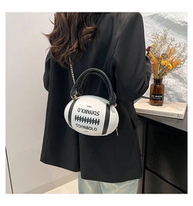 Detail showing the football shaped handbag with metal chain strap and brand lettering