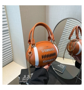 Macro detail of rugby-shaped handbag showing orange lychee texture and chain strap