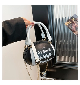 Detailed close-up of rugby-shaped leather bag with chain strap and SDIYABOLO branding