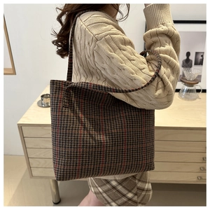 Side view of large plaid tote bag on shoulder, classic tweed pattern for daily commute