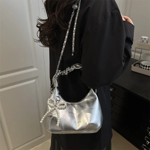 Metallic silver crescent moon handbag with pearl bow charm and chain strap for women