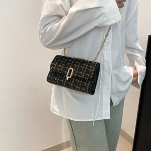 Classic black and gold tweed shoulder bag with elegant metal chain strap and twist lock