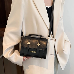 Vintage black lychee leather crossbody bag with gold hardware and top handle for women