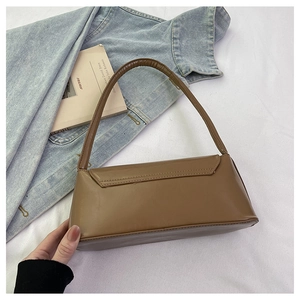 Vue détaillée du sac baguette en cuir marron avec une finition lisse et une bandoulière