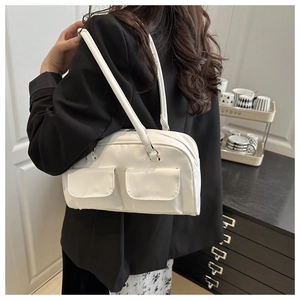 Detailed side view of white double-pocket shoulder bag on black blazer model