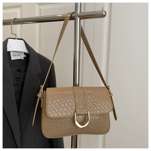 Detailed view of crocodile pattern leather texture with golden U-shaped buckle decoration
