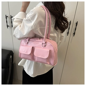 Pink PU leather shoulder bag with double pockets shown on model in minimalist interior