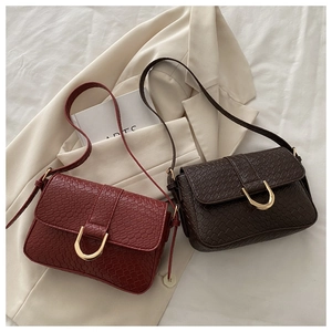 Detail of red and coffee faux crocodile leather bags with gold U-shaped metal buckle