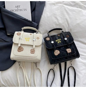 Detail of vintage cream and black mini backpack with cute toast and bear embroidery