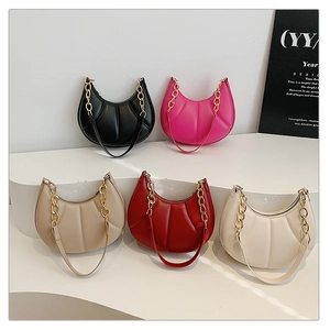 Detail view of crescent handbags in five colors with quilted leather and gold chain straps