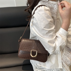 Retro brown crocodile embossed shoulder bag with gold metal hardware on model