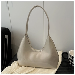 Detailed view of cream patent leather hobo bag with zip closure and GALOAD CULT logo