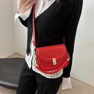 Classic red leather saddle handbag with gold buckle and crossbody strap for women