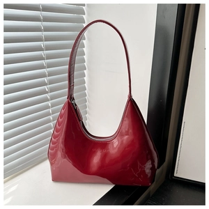 Close-up of shiny red patent leather hobo bag featuring silver Gaload Cult logo detail
