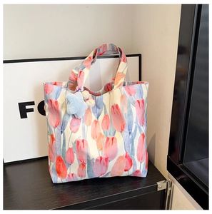 Detail of floral tote bag with watercolor tulips and a blue star plush keychain