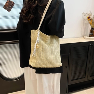 Large beige woven straw tote bag with cotton rope handles and stylish striped scarf detail