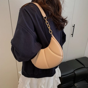 Beige crescent underarm bag with pleated texture and stylish gold chain detail