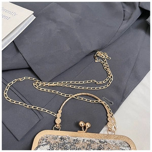 Detailed view of champagne sequins evening bag with engraved gold metal handle and chain