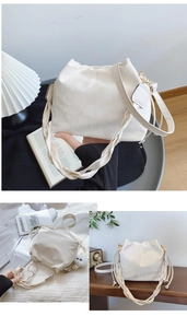 Détail du sac seau crème avec poignée tressée, cordon latéral et finitions dorées