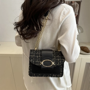 Elegant plaid tweed chain crossbody bag with golden clasp worn over the shoulder