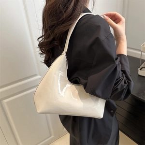 Glossy cream patent leather hobo bag for women with minimalist brand embossing