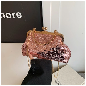 Detail of rose gold sequin clutch bag with vintage metal frame and kiss-lock closure