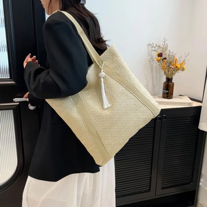 Grand sac cabas en paille crème avec pompons et sangles tissées pour les vacances