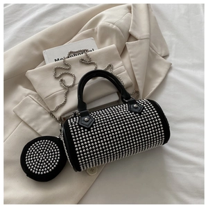 Detailed shot of black rhinestone cylinder bag with metal chain and matching coin purse