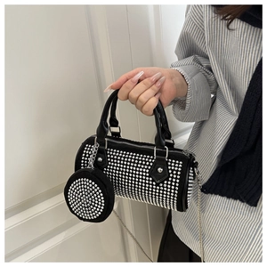 Detail of black rhinestone cylinder bag with matching round coin purse and silver chain
