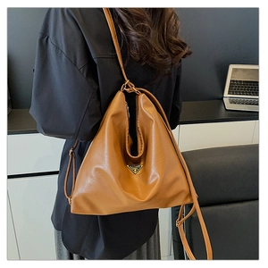Brown faux leather hobo bag with gold triangular metal logo and adjustable shoulder strap