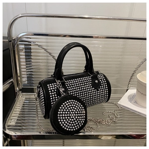 Detail of black rhinestone cylinder bag with metallic chain strap and matching coin purse