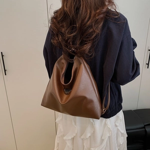 Minimalist dark brown oversized faux leather tote bag with unique triangular silhouette