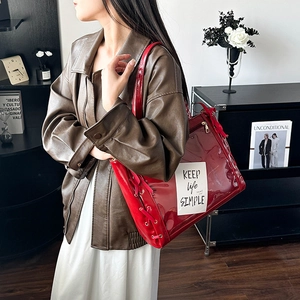 Red ribbon tote bag with transparent pocket shown in a stylish lifestyle setting