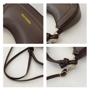 Detail view of coffee PU leather handbag with knot strap, zipper, and gold hardware