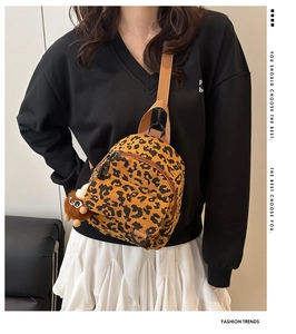 Detail of leopard print corduroy crossbody bag with cute plush eye doll charm