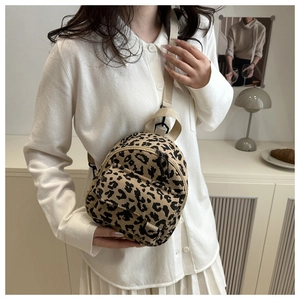 Detail of leopard print corduroy mini backpack showing soft texture and crossbody strap