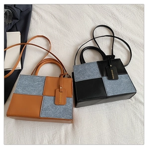 Detail of vintage square crossbody bags featuring denim patchwork and leather top handles