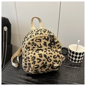 Detail of leopard print corduroy texture and zippers on the fashionable crossbody bag