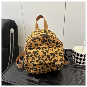 Close-up of leopard print corduroy mini backpack with detailed dual zipper and front pocket