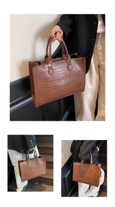 Detail of the brown crocodile texture and spacious compartment of the luxury tote bag