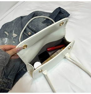 Internal view of the white leather tote showing spacious storage for cosmetics