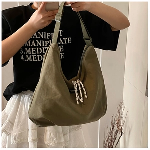 Macro detail of olive green nylon tote bag featuring durable rope and fashion label