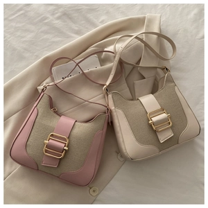 Detail of color-block canvas and leather shoulder bags with gold rectangular buckles