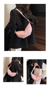 Detail of light pink waxed leather crescent bag with adjustable wide shoulder strap