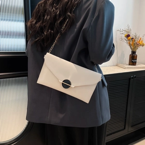 Élégant sac enveloppe blanc en cuir PU avec bandoulière dorée sur fond sombre